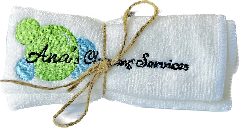 Blue microfiber cleaning cloth with Ana's Cleaning Services branding, folded neatly on a light surface